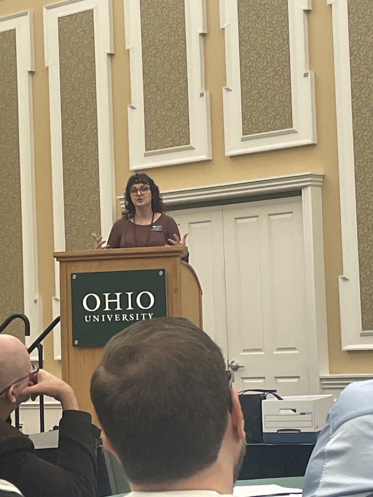 Dr. Jen Lisy speaking at an Ohio University podium